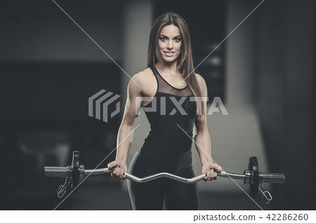Beautiful sexy athletic girl working out in gym Beautiful sexy athletic girl working out in gym 42286260
