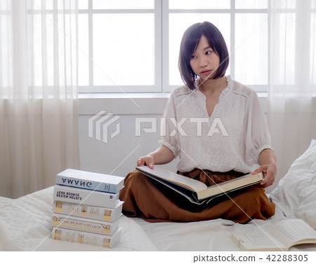 beautiful woman reading a book in morning beautiful woman reading a book in morning 42288305