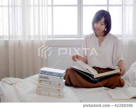 beautiful woman reading a book in morning beautiful woman reading a book in morning 42288306