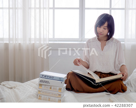 beautiful woman reading a book in morning beautiful woman reading a book in morning 42288307