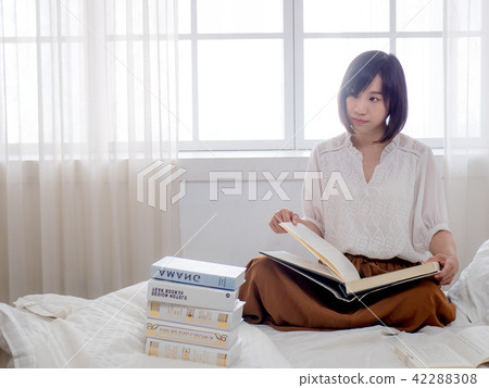 beautiful woman reading a book in morning beautiful woman reading a book in morning 42288308