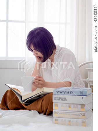 beautiful woman reading a book in morning beautiful woman reading a book in morning 42288354