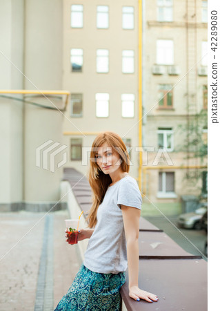 redhead model leaning on curb in the street redhead model leaning on curb in the street 42289080