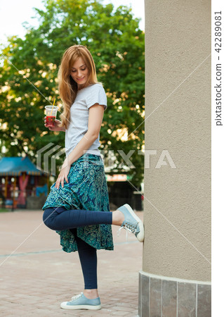 redhead girl standing near wall redhead girl standing near wall 42289081