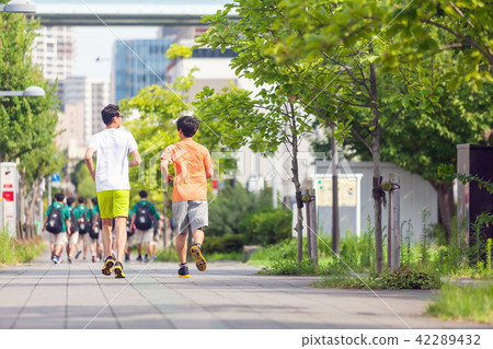 Jogging Young man running behind 42289432