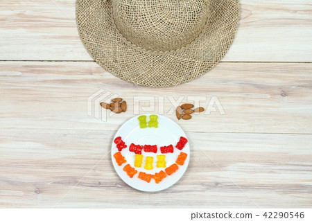 Face made from gummy bears, almond and hat Face made from gummy bears, almond and hat 42290546