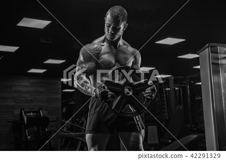 Black and white photo. Handsome man with a perfect abs muscle tr Black and white photo. Handsome man with a perfect abs muscle tr 42291329