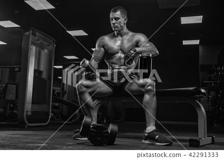 Black and white photo. A young handsome man, an athlete bodybuil 42291333