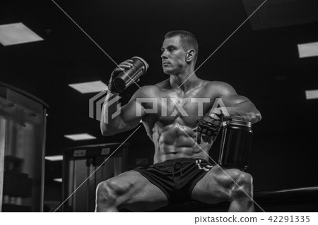 Black and white photo. Drinking protein looking for a shaker, ke Black and white photo. Drinking protein looking for a shaker, ke 42291335