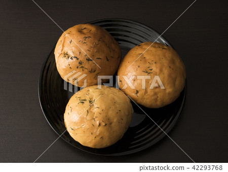 Three rolls on a black plate Three rolls on a black plate 42293768