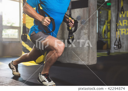 Male taking exercise with trx Male taking exercise with trx 42294874