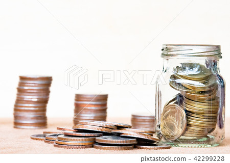 Coin in glass andthree pole range of coins. 42299228