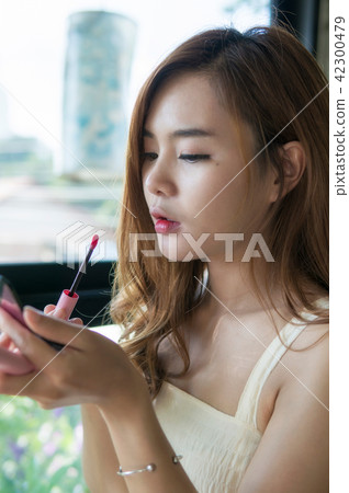 Woman with makeup brushes face. Asian beauty. 42300479