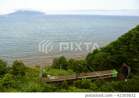 Takatsuki Strait and Limited Express Super Swan (789 series + 785 series) with Mt. Hakodate mountain back 42303632