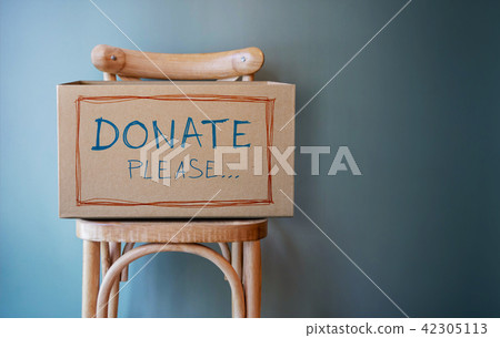 Donation Concept. Empty Donate Box on Chair Donation Concept. Empty Donate Box on Chair 42305113