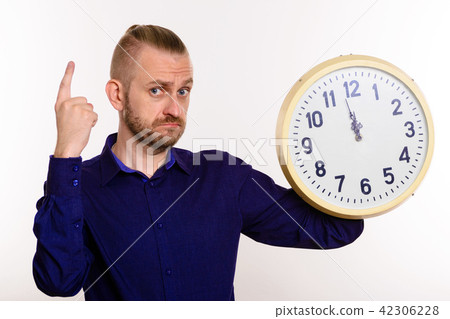 stylish man holds wall clock and points finger up stylish man holds wall clock and points finger up 42306228