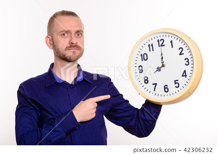man holding a large clock points finger at them man holding a large clock points finger at them 42306232