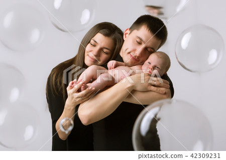 baby on the hands of parents on a white background. baby on the hands of parents on a white background. 42309231
