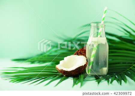 Bottle of coconut water and fresh ripe fruits on Bottle of coconut water and fresh ripe fruits on 42309972