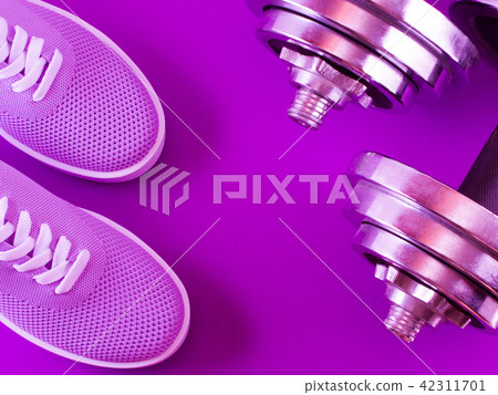 Violet sneakers on a purple background. Violet sneakers on a purple background. 42311701
