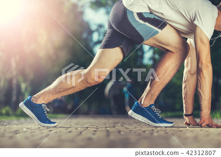 Fit athlete stretching before race 42312807