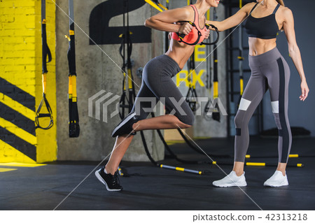 Female instructor is holding crossfit for girl 42313218
