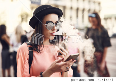 Serene woman typing in mobile Serene woman typing in mobile 42313271