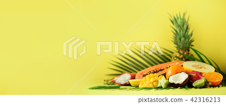 Assortment of exotic fruits on yellow background 42316213