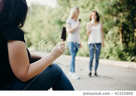 Obese woman eating ice cream envy to fit girls 42320808