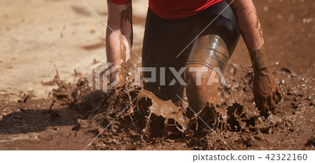 Mud race runners,during extreme obstacle races Mud race runners,during extreme obstacle races 42322160