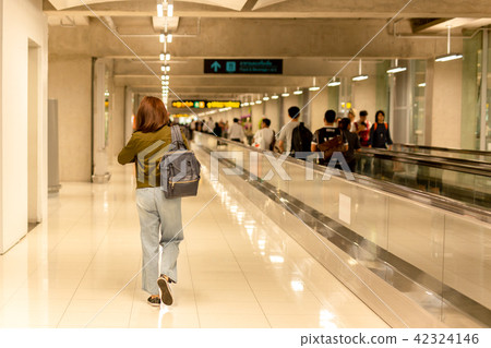 Woman with backpack walking to the gate in airport 42324146