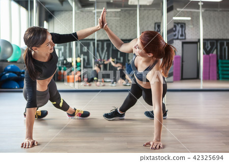 Beautiful women working out in gym together 42325694