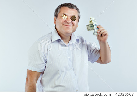 Businessman with dollars and bitcoins. Businessman with dollars and bitcoins. 42326568