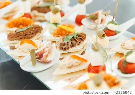 Snacks, fish and meat specialities on the buffet. 42326942