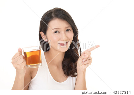 A woman drinking tea A woman drinking tea 42327514