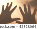 Black silhouette on white sand, open the palm of t 42328064