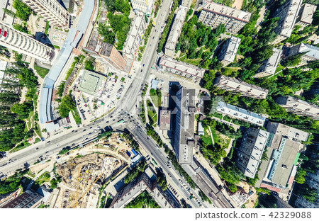 Aerial city view with crossroads and roads, houses, buildings, parks and parking lots. Sunny summer 42329088