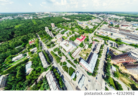 Aerial city view with crossroads and roads, houses, buildings, parks and parking lots. Sunny summer 42329092