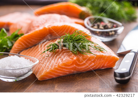 Raw salmon fillet with dill lemon olive oil salt Raw salmon fillet with dill lemon olive oil salt 42329217