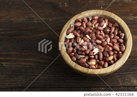 peanuts in a wooden plate 42331168