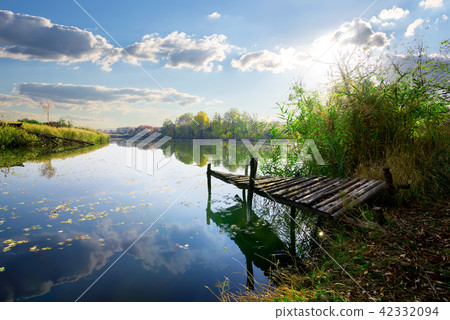 Old pier on pond 42332094