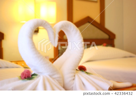 blurry photo of swans shaped of white towel blurry photo of swans shaped of white towel 42336432