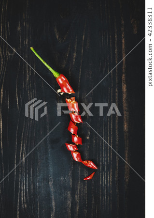 Red hot chilli pepper on black wood, top view 42338311