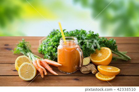 glass jug of carrot juice, fruits and vegetables glass jug of carrot juice, fruits and vegetables 42338510