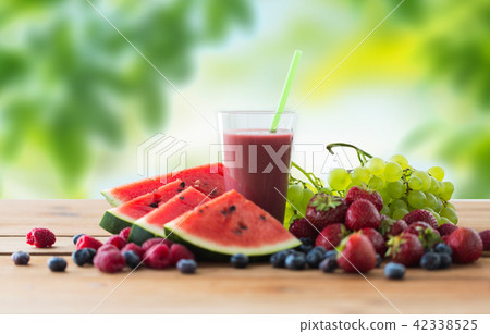 fruit and berry juice or smoothie on wooden table fruit and berry juice or smoothie on wooden table 42338525