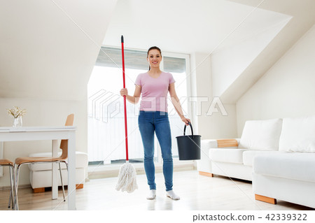 woman or housewife with mop cleaning floor at home woman or housewife with mop cleaning floor at home 42339322