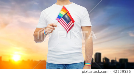 gay man with american flag and rainbow wristbands 42339526