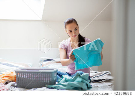 woman or housewife sorting laundry at home woman or housewife sorting laundry at home 42339698