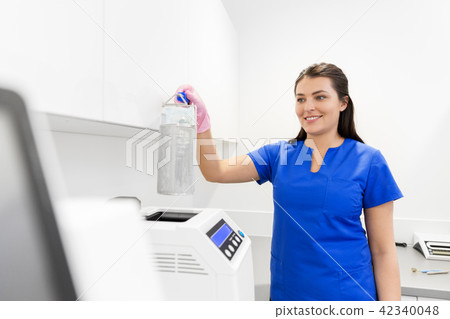 dentist sterilizing tools at dental clinic 42340048