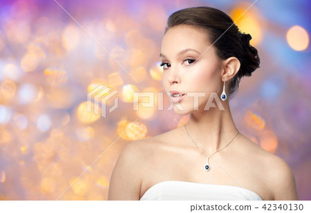 beautiful asian woman with earring and pendant beautiful asian woman with earring and pendant 42340130